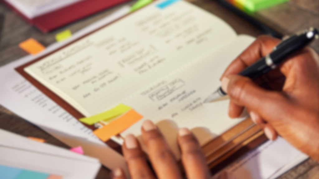 Close up of black businesswoman writing notes